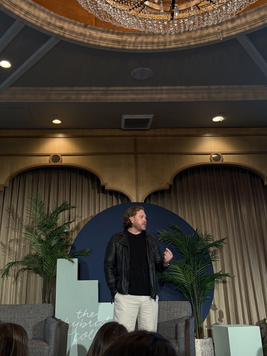 Paul Von Rieter speaking on stage at The Hybrid Co, full figure